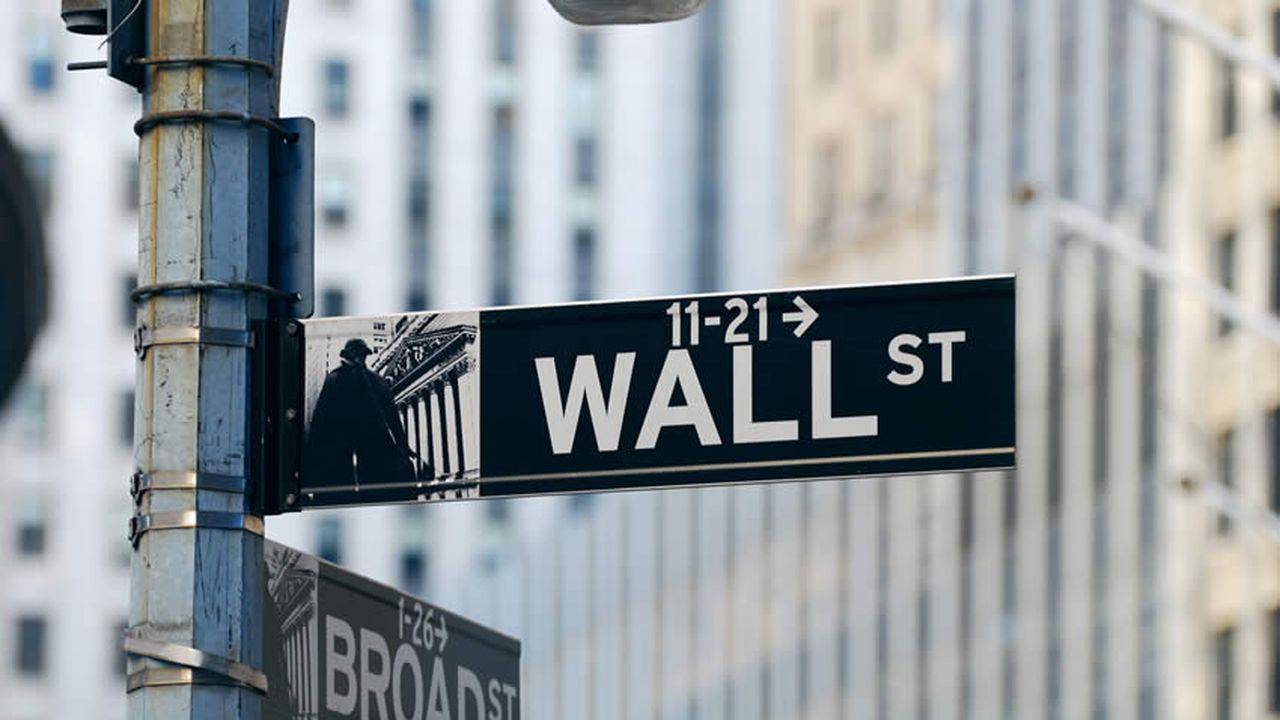 Wall Street ends higher, dollar firms ahead of a big week for market risk